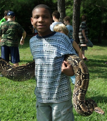 holding a huge snake at summer camp